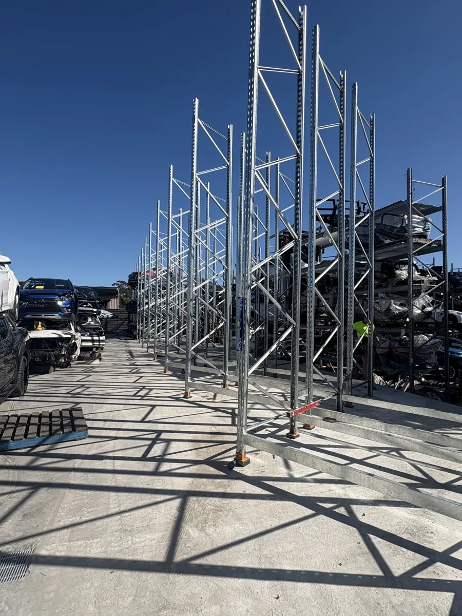 Tall galvanised cantilever racking against a blue sky