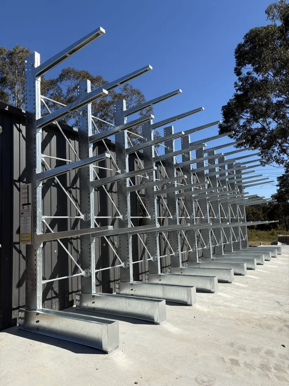 Galvanised cantilever racks viewed along an outdoor storage lane