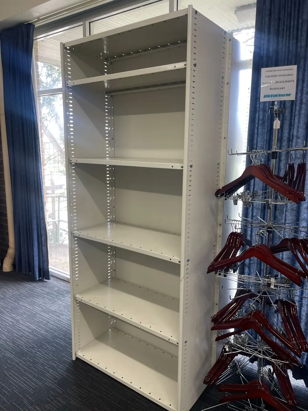 Grey metal shelving unit displayed in a commercial interior