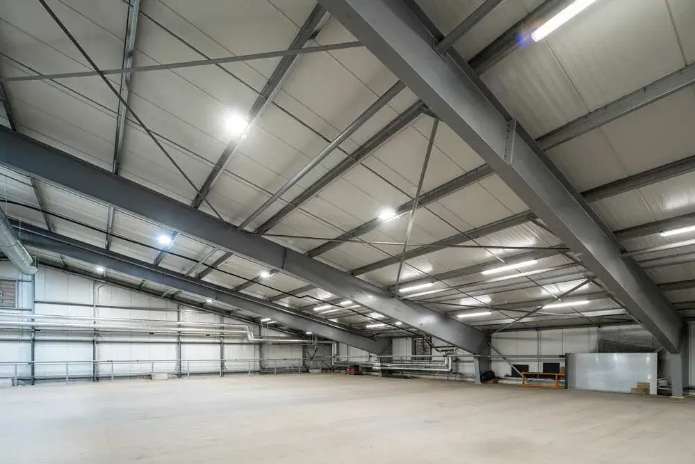 Open warehouse interior with a high steel roof