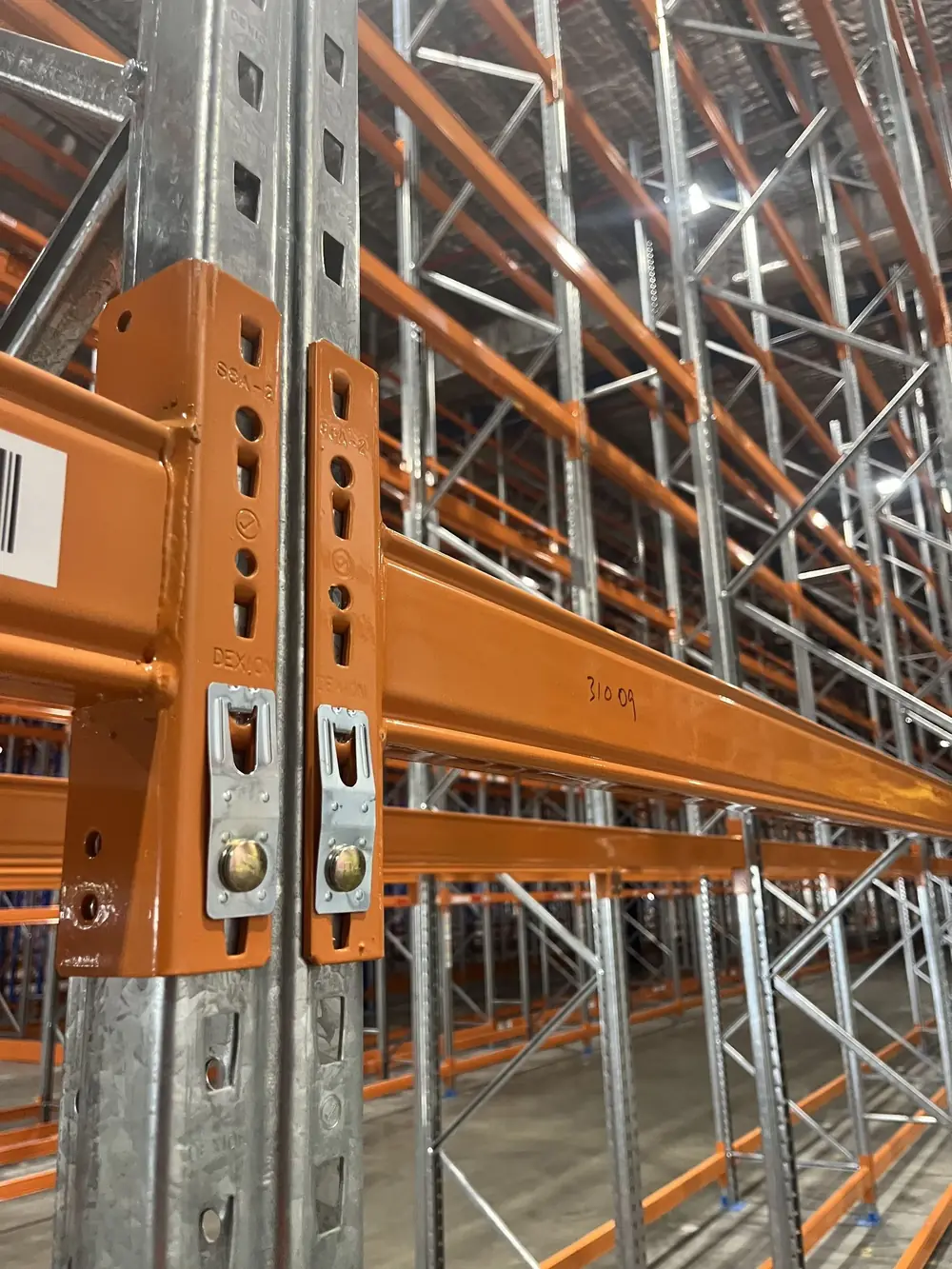 Close-up of an orange pallet-racking beam connection